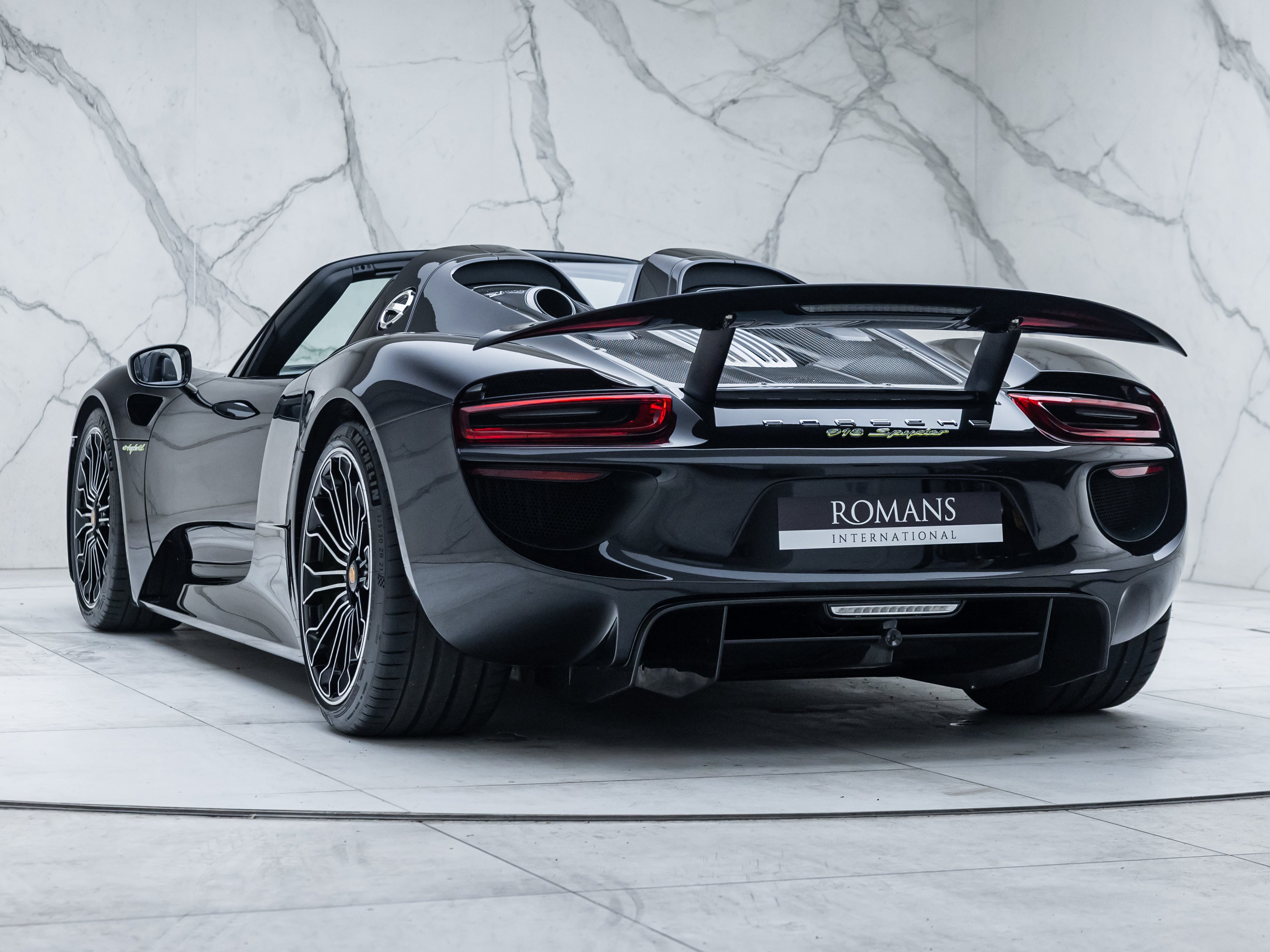 Porsche 918 Spyder rear three-quarter with rear wing raised at Romans International