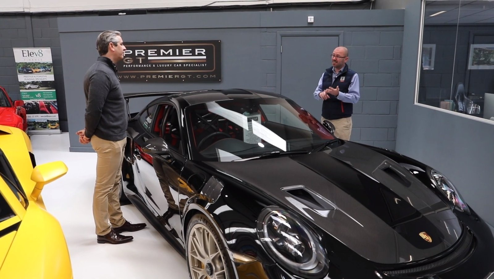 Two men admiring a supercar