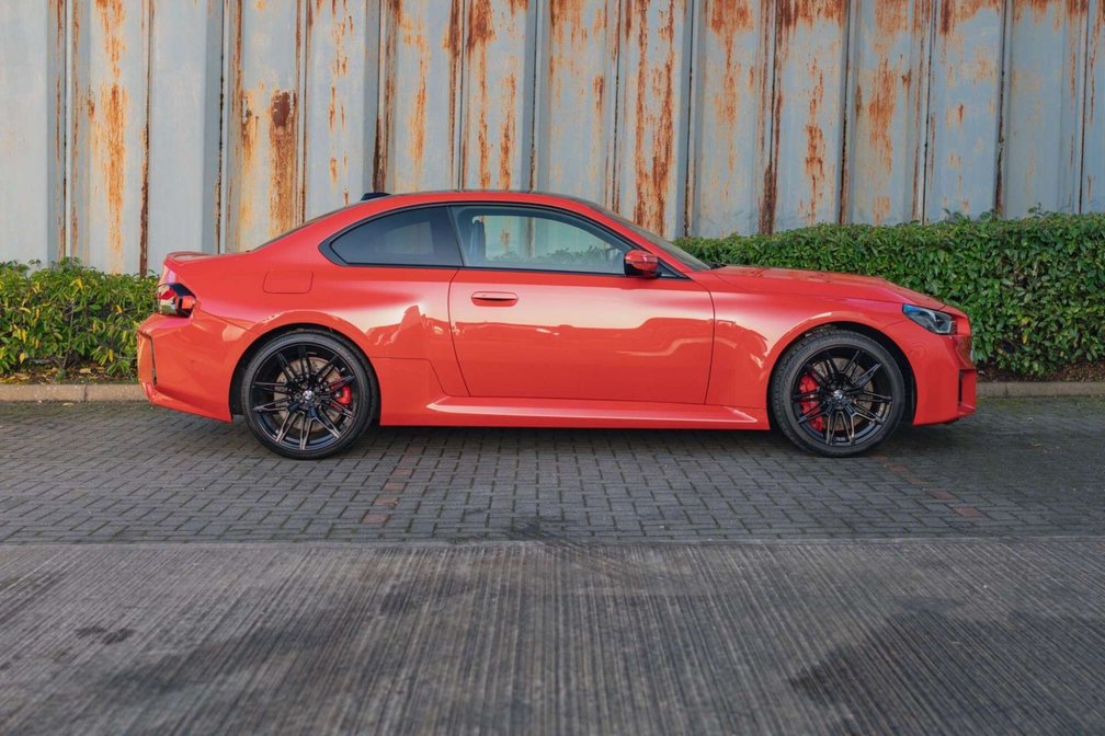 BMW M2 side profile in Toronto Red